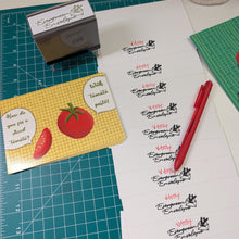 Load image into Gallery viewer, A tabletop craft scene showing printed tomato-themed labels or stickers on a white sheet, alongside a green cutting mat, a stamp block, a red pen, and a yellow card with tomato illustrations. No person or animal is present, but this is not a clean isolated product shot; it is a styled workspace scene, so Product/Packaging is the best fit because the image is still centered on the product being made rather than a real environment as the subject.
